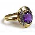 A 9ct gold, amethyst and diamond ring, the oval cut amethyst of approximately 7.3 by 6mm, with three... 