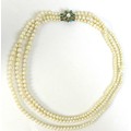 A simulated pearl triple strand necklace with 9ct gold turquoise and pearl clasp of starburst design... 