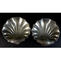A pair of Edward VII silver shell form dishes, raised upon three ball feet, Atkin Brothers, Sheffiel... 