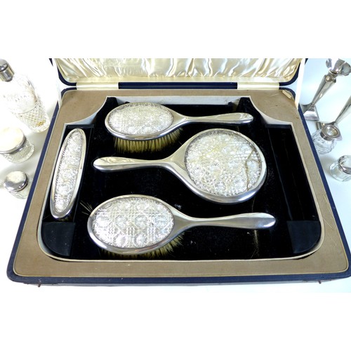 60 - A group of George V silver dressing table items, comprising a cased part set silver and glass backed... 