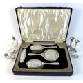 A group of George V silver dressing table items, comprising a cased part set silver and glass backed... 