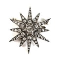 A late Victorian diamond set starburst brooch, the central diamond of approximately 0.25ct, 3.8mm, s... 