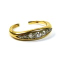 An 18ct gold and diamond seven stone ring, the old cut diamonds in a rub over setting, total diamond... 