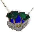 A silver and enamel necklace in the form of a grey owl flying in a midnight forest, enamelled in blu... 