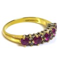 An 18ct gold ruby and diamond half eternity ring, set with five rubies interspersed with four pairs ... 