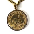 A 1952 George VI South Africa gold £1 coin, set in unmarked pendant mount with 9ct gold chain, total... 