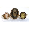 A group of three 9ct gold rings, comprising a citrine ring, size L, a cameo ring, size N, and a smok... 