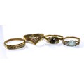 A group of four 9ct gold rings, comprising an aquamarine style ring, size I, a sapphire and diamond ... 