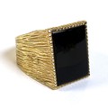 A 9ct gold gentlemen's ring, set with a rectangular cut and polished black stone, possibly jet, 19.5... 