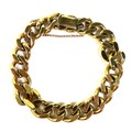 A 9ct gold kerb link bracelet, with safety chain attached and press clasp, links 12 by 4mm, FM, Lond... 
