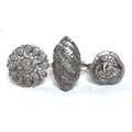 A group of three diamond dress rings, comprising a ring of ornate trefoil design, 20mm diameter, siz... 