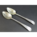 Two George III old English pattern silver table spoons, both with bright cut decoration, one with 'M... 