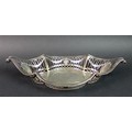 An Edwardian silver bowl, of oval form with scroll tips to each end and pierced decoration four blan... 
