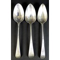 Three George III old English pattern silver table spoons, comprising one with bright cut decoration ... 