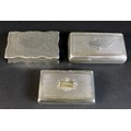 An early 20th century silver box of scallopped rectangular form with engraved scrolling acanthus to ... 