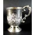 An Anglo Indian colonial silver christening tankard, with repousse Rococo style floral decoration in... 
