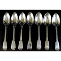 Seven George III and later silver fiddle pattern dessert spoons, comprising four George III spoons, ... 