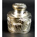 A Chinese silver inkwell of cylindrical form with irises surrounding, and butterfly to the lid, thre... 