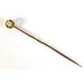 A Victorian unmarked yellow gold diamond set stick tie pin, the 0.15ct, 3.5 by 3.0 by 1.5mm, oval cu... 