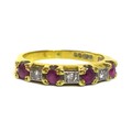 An 18ct gold, ruby and diamond seven stone ring, each of the four rubies of approximately 2.8mm, int... 