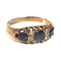 A 9ct rose gold, sapphire and diamond dress ring, set with three graduated sapphires, approximately ... 
