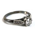 An 18ct white gold, platinum and diamond solitaire ring, of Art Deco design, the central diamond of ... 
