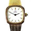 An Omega 9ct gold cased lady's wristwatch, model 7115598, circa 1990, the square white dial with rou... 