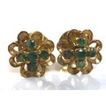 A pair of emerald cluster earrings, in yellow metal flower setting with quatrafoil of five small eme... 