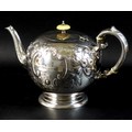 A Victorian silver teapot, of bullet form with scroll handle and foliate clasped spout, decorated wi... 