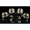 Two pairs of Georgian silver cauldron salts and salt spoons, comprising a George III pair with fine ... 