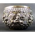 An early 20th century Burmese white metal bowl, intricately repousse decorated and chased with a con... 