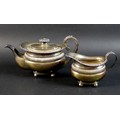 A late 19th/early 20th century Dutch silver teapot and milk jug, the teapot with foliate clasped scr... 