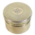 An Asprey George V silver gilt lidded box, cylindrical with machine engraved decoration, the lid wit... 