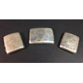 Three George V silver cigarette cases, comprising , two with foliate engraved designs and monograms ... 