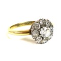 An 18ct gold diamond daisy cluster set ring, the central diamond 0.25ct, 4.4mm, surrounded by eight ... 