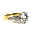 An 18ct gold solitaire ring, set with a large and impressive white stone, likely white sapphire, app... 