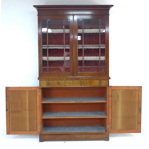 302 - A late Victorian mahogany glazed bookcase, twin glazed doors enclosing shelves, the base section wit... 