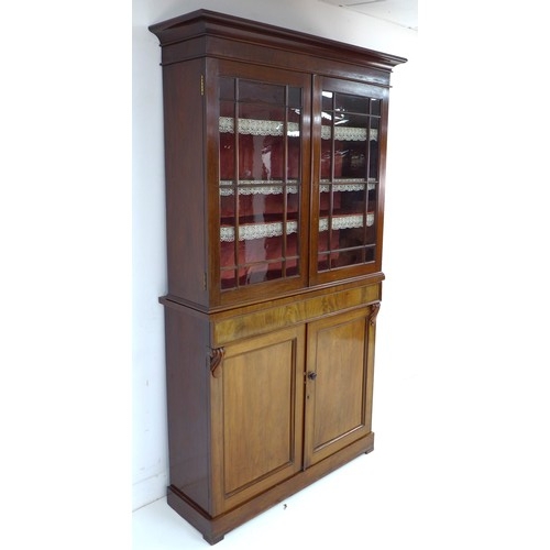 302 - A late Victorian mahogany glazed bookcase, twin glazed doors enclosing shelves, the base section wit... 