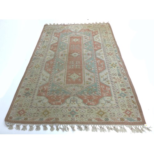 305 - A modern Persian rug with cream ground, pale blue and pink floral decoration, end tassels tied in bu... 