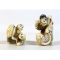 Two Japanese Meiji Period ivory katabori netsuke, one of a man playing with a child using a large fa... 