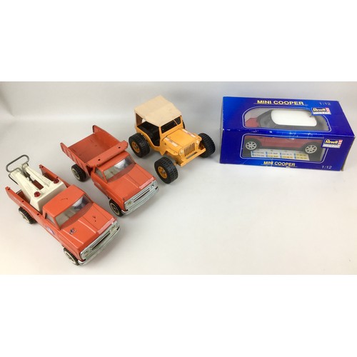 149 - A Revell Metal 1:12 scale Mini Cooper, with original box, and three Tonka vehicles, without boxes, i... 