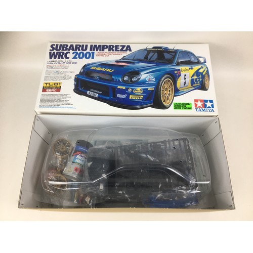 150 - A Tamiya 1:10 scale Suburu Impreza RC car kit and a Super Radio Tron 1:11 scale BMW M1 G-4 car, both... 