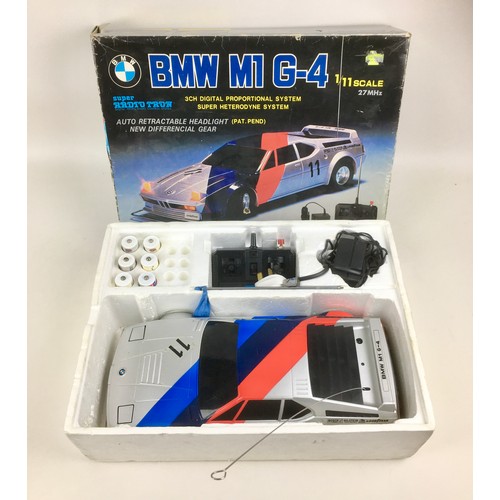 150 - A Tamiya 1:10 scale Suburu Impreza RC car kit and a Super Radio Tron 1:11 scale BMW M1 G-4 car, both... 