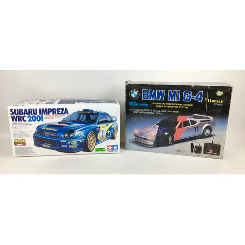 150 - A Tamiya 1:10 scale Suburu Impreza RC car kit and a Super Radio Tron 1:11 scale BMW M1 G-4 car, both... 