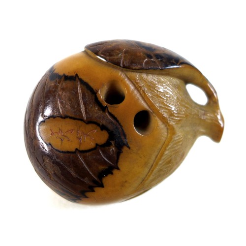 12 - A Japanese Katabori netsuke, likely Meiji period, made out of a tagua nut and shell and carved in th... 