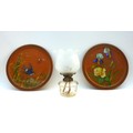 A pair of Watcombe Torquay terracotta chargers, one decorated with a swallow flying amongst reeds an... 