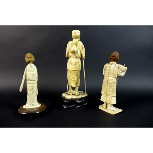 19 - A group of three late 19th /early 20th century ivory okimonos, comprising a figure of an elder, with... 