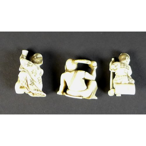 16 - A group of Japanese Meiji period ivory figures comprising three netsuke, one of a gentleman with a s... 