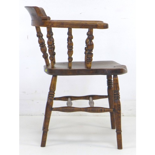 309 - A 19th century burr oak and elm smoker's bow armchair, with shaped arms supported on turned spindles... 