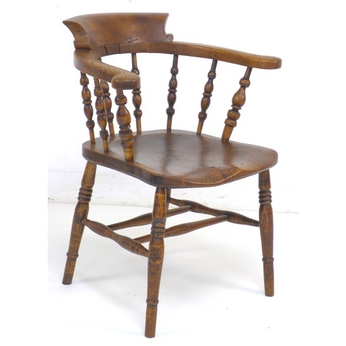 309 - A 19th century burr oak and elm smoker's bow armchair, with shaped arms supported on turned spindles... 